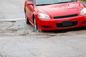 Car hitting pothole